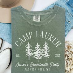 the camp lauren t - shirt is next to some shoes