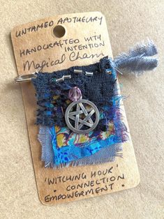 a piece of cloth with an inverted pentagramter on it and some other items attached to it