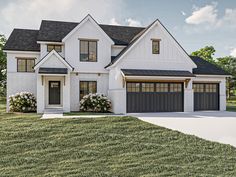 a white house with two garages on the front and one above it's doors