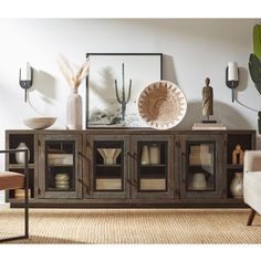 a living room scene with focus on the sideboard and vases in the background