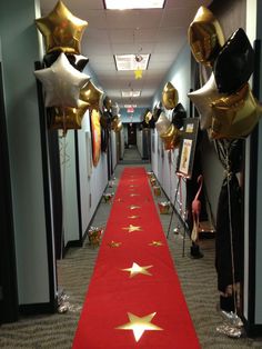 the hallway is decorated with gold stars and balloons