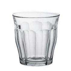 a clear glass cup sitting on top of a white table