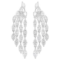 These breathtaking chandelier earrings feature 5.35 carats of marquise-cut diamonds, elegantly crafted in 14 karat white gold. The diamonds, with SI1-SI2 clarity and H-I color, are arranged to create a dazzling cascade of light and brilliance. Weighing 8.63 grams, these earrings are both luxurious and comfortable for extended wear. Measuring approximately 36 mm in length, their intricate design and shimmering diamonds make them a standout piece for any special occasion. With 7.56 grams of high-quality 18k white gold, these earrings add a touch of refined elegance and timeless beauty to your jewelry collection. FOLLOW SPECTRUM JEWELS storefront to view the latest collection & exclusive pieces. Spectrum Jewels is proudly rated as a Top Seller on 1stDibs with 5 star customer reviews. All item Earring Video, Diamond Chandelier Earrings, Diamond Chandelier, Marquise Cut Diamond, White Gold Jewelry, Marquise Diamond, Modern Earrings, Marquise Cut, Intricate Design