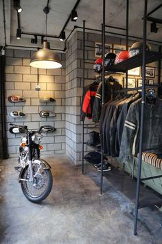 a motorcycle is parked in the middle of a room filled with clothes and other items