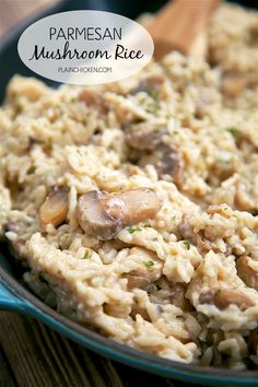 mushroom rice with parmesan in a blue skillet on a wooden table and text overlay that reads parmesan mushroom rice