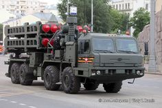 an army truck driving down the street