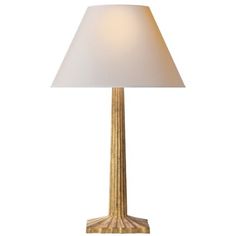 a gold lamp with a white shade on it