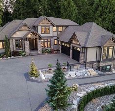 an aerial view of a large home with lots of windows and trees in the front yard