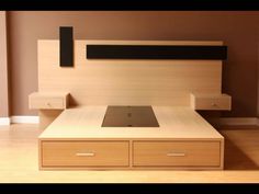 a bed with two drawers and a laptop on it