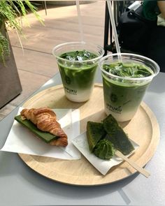 two cups of green tea and croissant on a plate