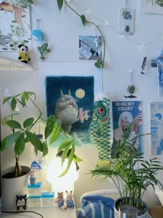 a room with plants and pictures on the wall