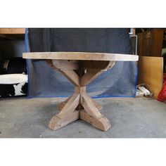 a wooden table sitting on top of a cement floor