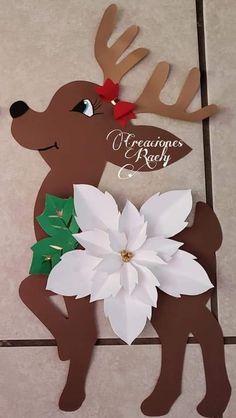 a paper cut out of a deer holding a flower