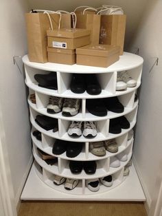 a white shoe rack filled with lots of shoes