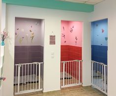 two doors with flowers painted on them in a room that has pink, blue and purple walls