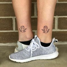 a woman's legs with two small tattoos on them