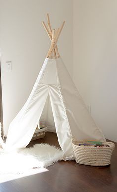 a teepee sitting on top of a wooden floor