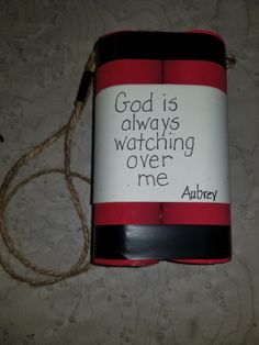 a red and black can with a message on it that says god is always watching over me