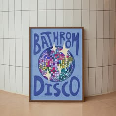 a bathroom with tiled walls and tile flooring, there is a painting on the wall that says bath from disco