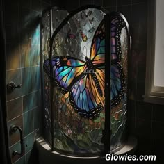 a glass shower with a colorful butterfly on it