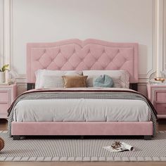 a pink bed in a bedroom with white walls and wooden floors, along with two nightstands