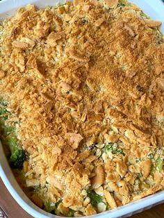 a casserole dish with chicken and broccoli covered in crumbs