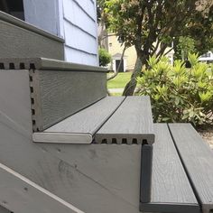 a close up view of the bottom part of a house's porch with gray siding