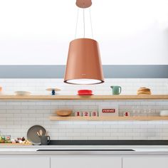 a kitchen filled with lots of counter space and hanging lights above the stove top oven