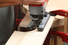 a man using a router on a piece of wood