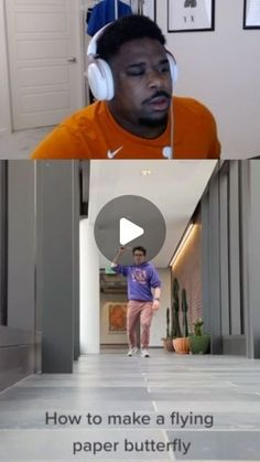 a man with headphones on walking down a hallway next to another man wearing an orange shirt