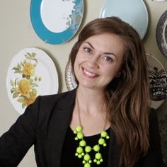 a woman standing in front of plates on the wall