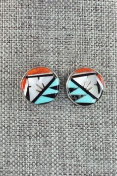 These turquoise, mother of pearl, coral, and onyx inlay sterling silver earrings were made by Zuni silversmiths Leif Esalio and M. Booqua. The back is signed MBZ.Length: 5/8"Width: 5/8"Free shipping on all orders! We ship with USPS and always include tracking. All orders ship within a day of payment.Returns are accepted up to 30 days after you receive your order. Just send us a message. Our shop offers cash back or store credit. The item must be returned in new condition. Silver Inlay Earrings, Silver Inlay Round Earrings, Unique Silver Earrings With Inlay, Southwestern Silver Earrings With Inlay, Inlay Jewelry, Zuni Jewelry, Native Jewelry, Multi Stone, Native American Jewelry