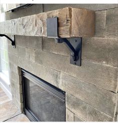 the fireplace is made out of wood and has metal brackets on it