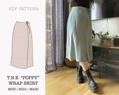 a woman wearing a skirt and boots standing in front of a window with the text, the poppy wrap skirt mini / mid - max