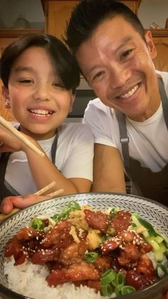 the man and woman are posing for a picture with their meal in front of them