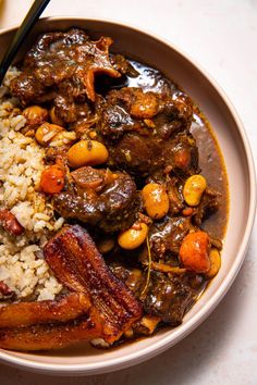 a bowl filled with rice, meat and vegetables