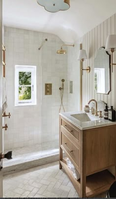 a bathroom with a sink, mirror and bathtub next to a walk in shower