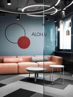 an office with black and white checkered flooring, leather couches and round tables