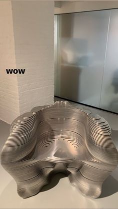 a large metal bowl sitting on top of a white table