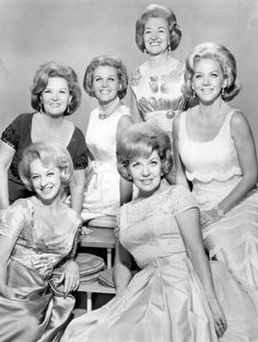 an old black and white photo of women in dresses