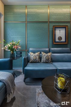 a blue couch sitting next to a table in a living room