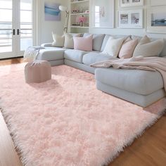 a living room filled with furniture and pink rugs