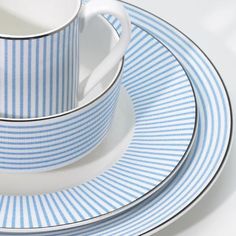 a blue and white striped plate with two cups