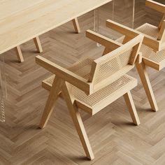 a wooden table with four chairs around it on top of a hard wood floored floor