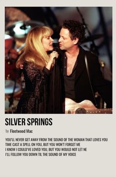 a man and woman singing into microphones in front of an advertisement for silver springs