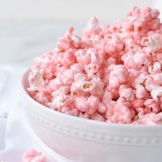 a bowl filled with pink and white popcorn