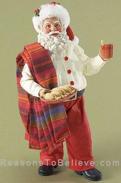 a figurine of santa claus holding a tray of bread and a cup of coffee