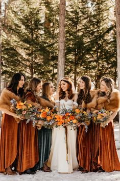 a group of women standing next to each other in the snow