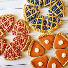 several decorated cookies are arranged on a white table