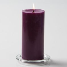 a purple candle is sitting on a glass stand with a white background and text that reads quick candles